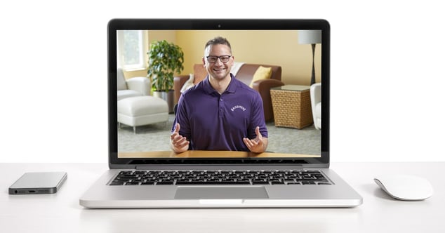Man in purple shirt presenting virtually