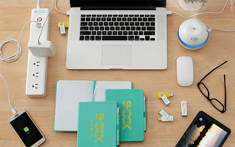 Desk with computer notebooks usb drives and blue light glasses