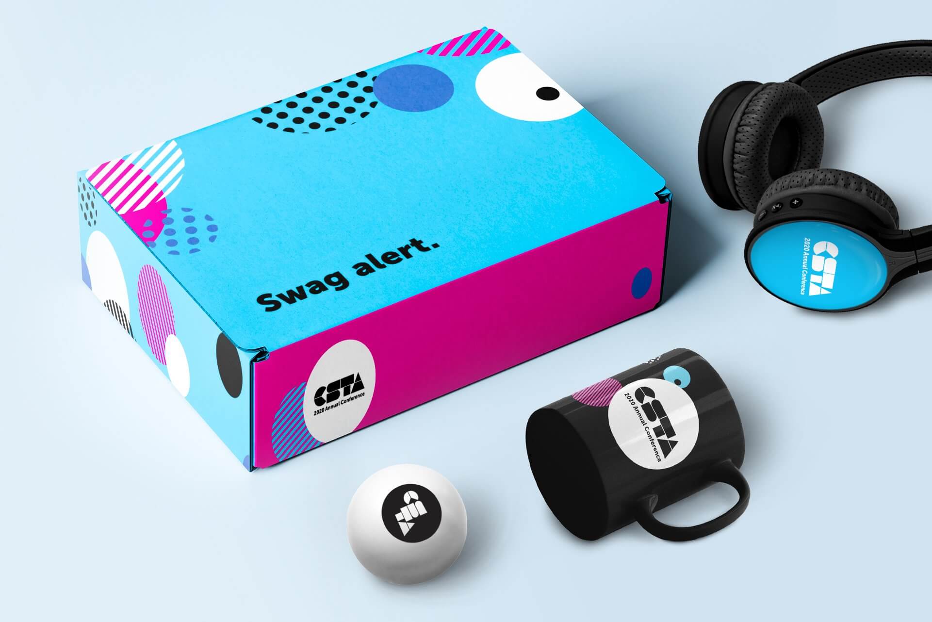 colorful box with swag alert written on it surrounded by a mug, ping pong ball, and headphones